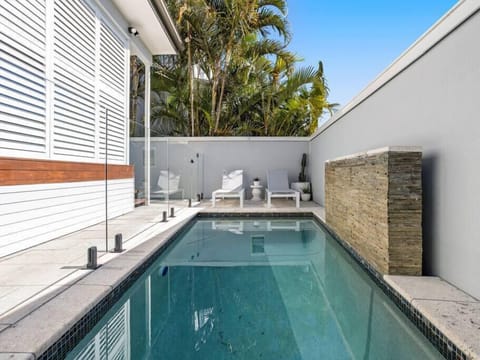 Villa Luxe Miami heated pool area with glass fencing, sun loungers and BBQ space