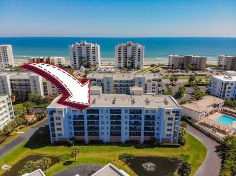 Aerial view of the building, with an arrow pointing towards the unit.