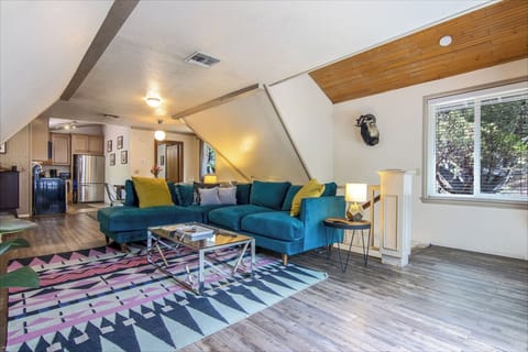 Living Room - stairs lead to 3 bdrm/1 bath, washer/dryer, foyer w/games & books