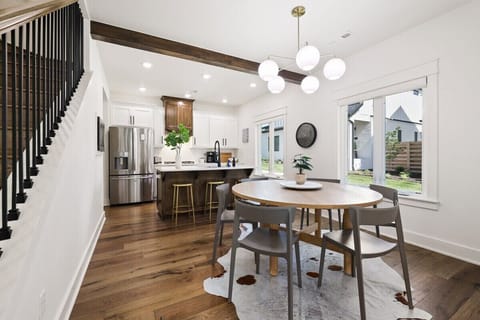 In between the living room and kitchen area, you'll see our round, 6-top dining table.