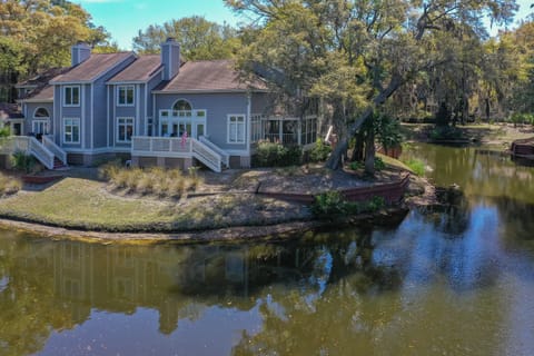 A striking exterior view showcases this beautifully positioned home set along a tranquil lagoon.