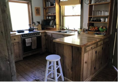 Cozy kitchen with microwave, stove, oven fridge, coffee maker and grinder
