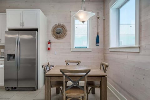 The dining room features a sleek and modern design with a warm and inviting atmosphere, making it the perfect space for entertaining guests or enjoying family meals