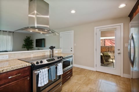 Bring a touch of warmth and style to your meals with the stunning kitchen outfitted with stainless steel appliances.