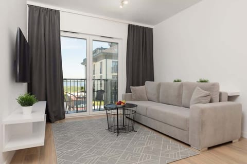 Relax in the stylish living room with a comfortable sofa and modern decor.