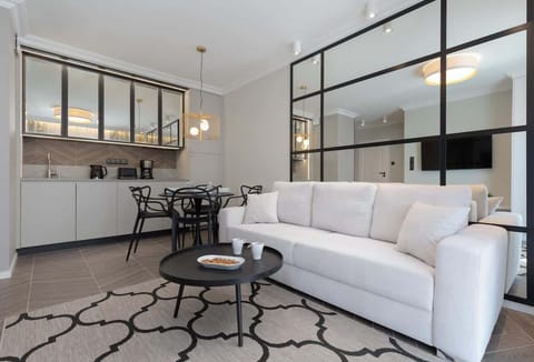 Relax in the stylish living room with a comfortable sofa and modern decor.