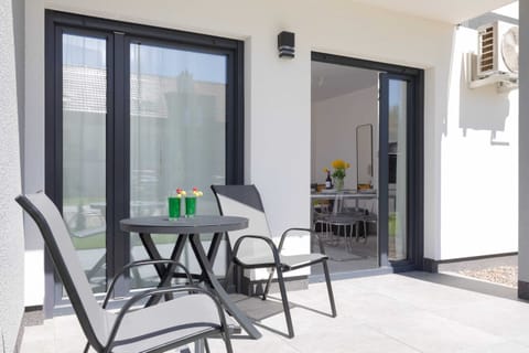 A small table on the terrace is ideal for outdoor dining or working.