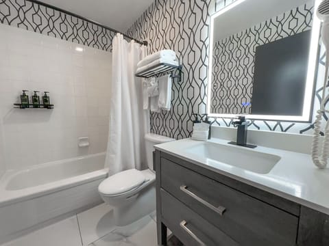 Deluxe Room, 2 Queen Beds | Bathroom | Designer toiletries, hair dryer, towels, soap