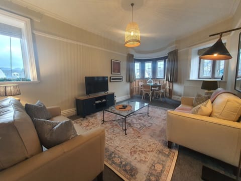 An impressive corner bay window is the focal feature of the open plan living and dining area