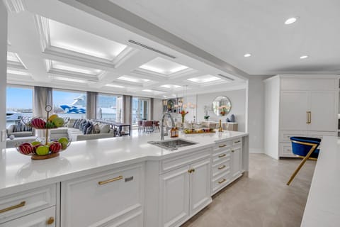 The gourmet kitchen opens on the dining room with seating for ten featuring incredible views of the inlet.