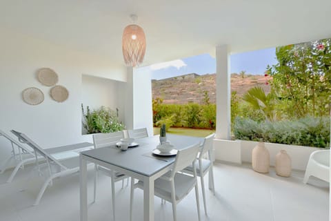 Large terrace with dining table and sunbathing area