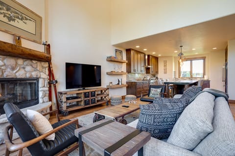 Relax in your open-concept living space where rustic charm meets modern comfort. Cozy up by the stone fireplace or unwind in the stylish kitchen.