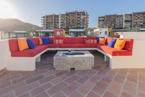Rooftop with firepit and cozy sitting area.