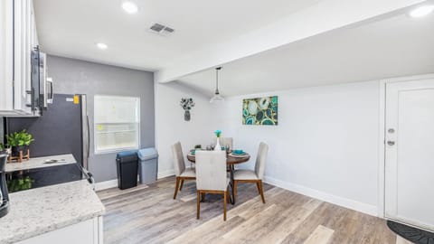This kitchen features functional cabinets that provide ample storage space for your kitchen essentials and appliances. Additionally, the same space includes a dining area with seating for four.