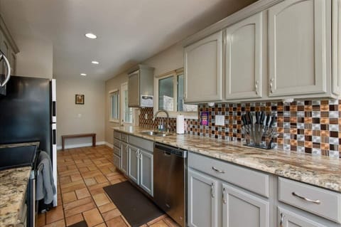 The galley kitchen space highlights contemporary counters and modern appliances.