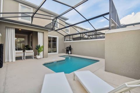 Step outside to your private oasis with a crystal-clear pool protected by a screen. Relax on sleek lounge chairs surrounded by light walls and enjoy outdoor dining just steps from your cozy indoor living space.