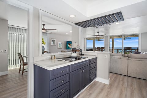 High-end kitchen with stainless appliances, breakfast bar, and wine glass rack.