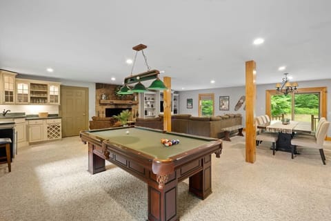 Spacious first floor with pool table, foosball, couches, wet bar, dining room and kitchen!