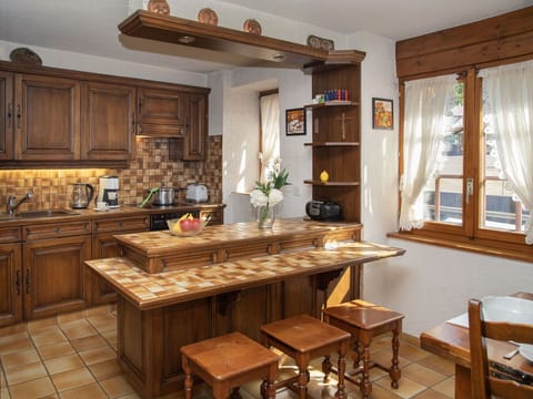 Furniture, Kitchen, Interior Design, Flooring, Countertop, Cabinetry, Wood, Floor, Lighting, Room