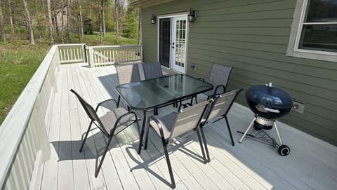 back deck with outdoor dining area and grill