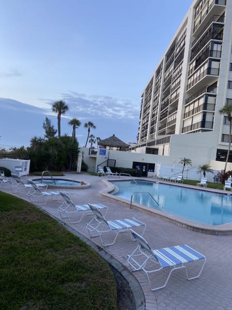 building from beach side with pool and hot tub