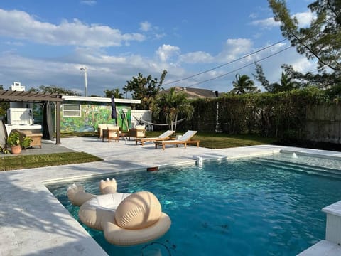 Completed in 2023, our oversized luxury pool comes with fountains, a waterfall and a unique, custom tropical mural on the back of the house. Enjoy this sliver of backyard paradise!