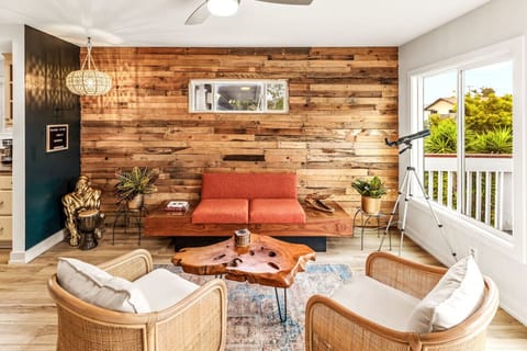 Escape to a serene chic lounge retreat and remote work oasis with wood accents, essential amenities, 3 bathrooms, an office space, and an upper deck with breathtaking views. Relax while preparing a drink or meal and snap a picture with our gorilla!