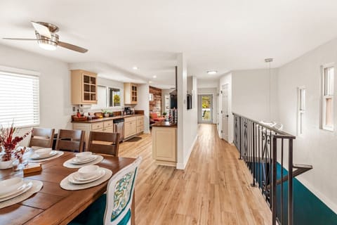 Take in the spaciousness and warm ambiance as you gaze from the front to back on the top floor, with the fully equipped kitchen with all the essentials for preparing a delicious meal, and a dining area comfortably seating up to 8 guests.