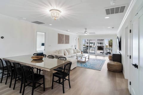 Spacious, family-style dining area with a large table, plus a counter with four stools; perfect for shared meals and easy conversation. The open layout flows seamlessly into the living room, keeping everyone connected.