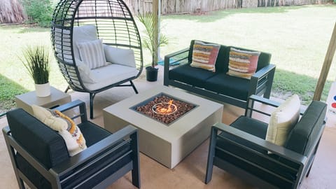 Outdoor patio lounge area, fire pit, string lights, 55" smart tv, games, dining!