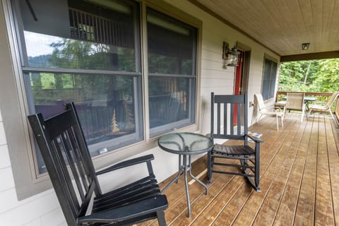 Deck with a Gas Grill, Quaint Table and Rocking Chairs