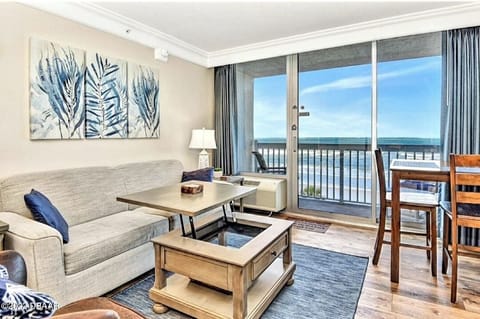 Large living area w/view of beach, ocean, pool, sleeper sofa, eating area, TV
