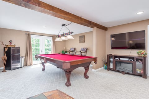 Pool table and family room with big screen TV and xBox 1S