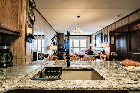 The kitchen features a newly installed (2024) granite countertops with bar seating.