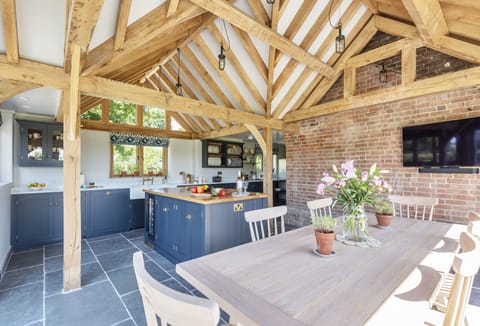 Hilltop Cottage, Wimborne: The impressive open-plan kitchen and dining area with Smart television