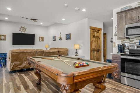 Game area with pool table and 70" smart TV