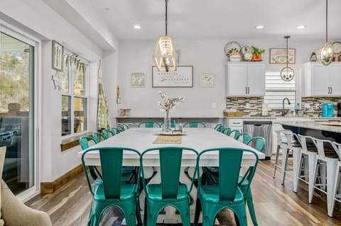 Seating for 30 with dining table, bar, and added bar along wall.