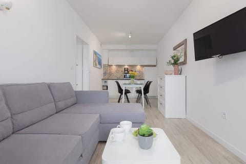 Living room with a comfortable sofa and TV. 