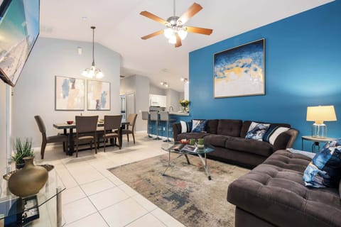 Dinner and a movie? Our dining table seats six comfortably, with a clear view of the wall-mounted Smart TV and easy access to the breakfast bar.