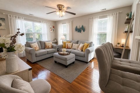 Comfortable living room with ample seating, a smart TV, and a peaceful view of t