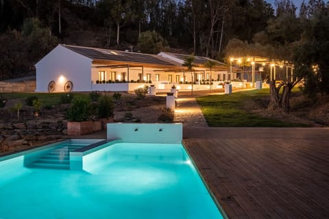Night view of the pool and gardens