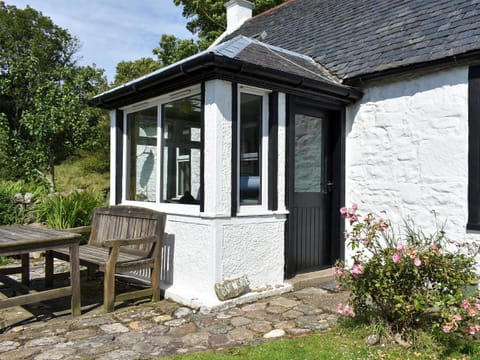 Tranquil patio with garden furniture | Burnside Cottage, Sliddery, Isle of Arran