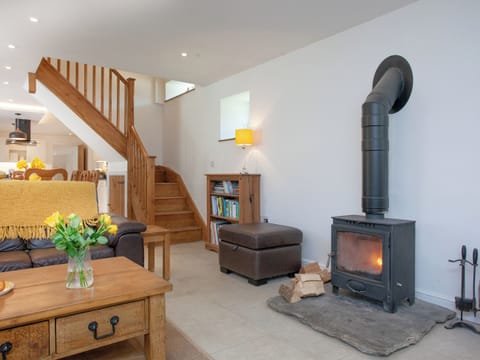 Living area with stairs to master bedroom | The Shippon - Barn Escapes, Ilfracombe