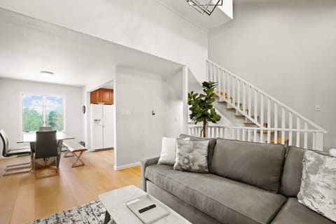 This angle highlights the convenient closeness of the living and dining areas, which has a lovely bay window for natural light and is adjacent to the kitchen.