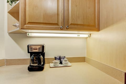 Complimentary 12 cup coffee maker and fixings are provided