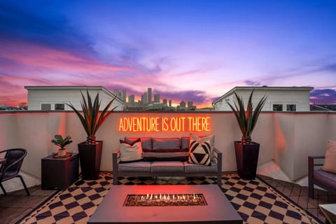 400 sq ft rooftop deck with STUNNING views of downtown. 2 large outdoor couches, one dining set, a grill, retractable awning, LED lights strips and custom neon sign, and a cozy firepit.
