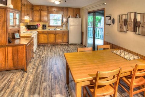 Kitchen with sliding doors that lead out to the porch and grill