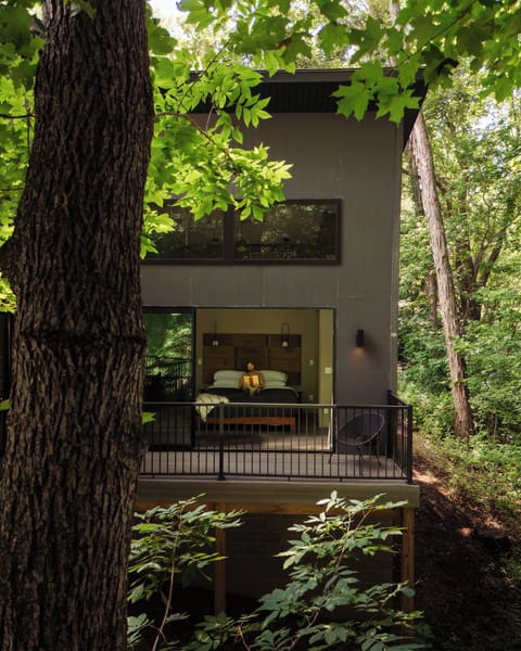Open the glass wall and let the forest become part of the bedroom.