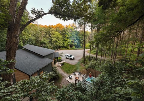 Tucked into the trees with a private hot tub and fire pit below.