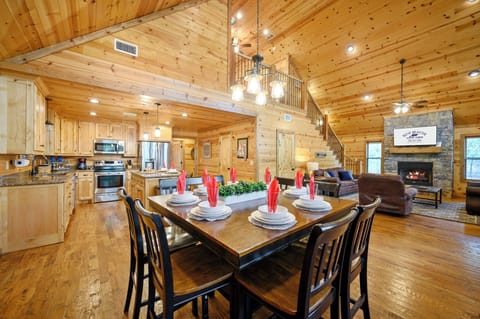 Warm wood paneling and an open floor plan invite you to gather around the dining table, cook in the fully-equipped kitchen, or relax by the stone fireplace in this welcoming mountain retreat.